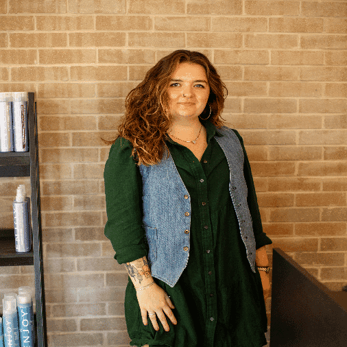 Portrait of Sam, a professional stylist at Salon JaDor, showcasing their expertise and style.