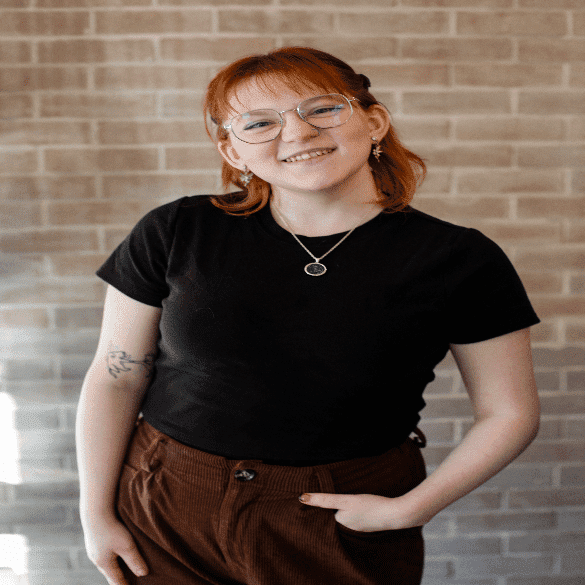 Portrait of Cheyenne, a professional stylist at Salon JaDor, showcasing their expertise and style.
