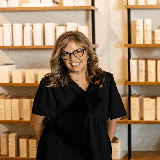 Portrait of Dora, a professional stylist at Salon JaDor, showcasing their expertise and style.
