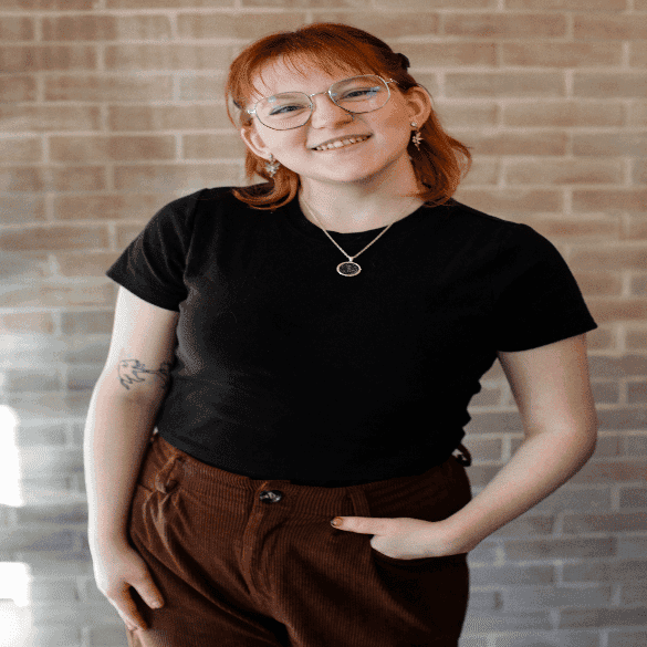 Portrait of Cheyenne, a professional stylist at Salon JaDor, showcasing their expertise and style.